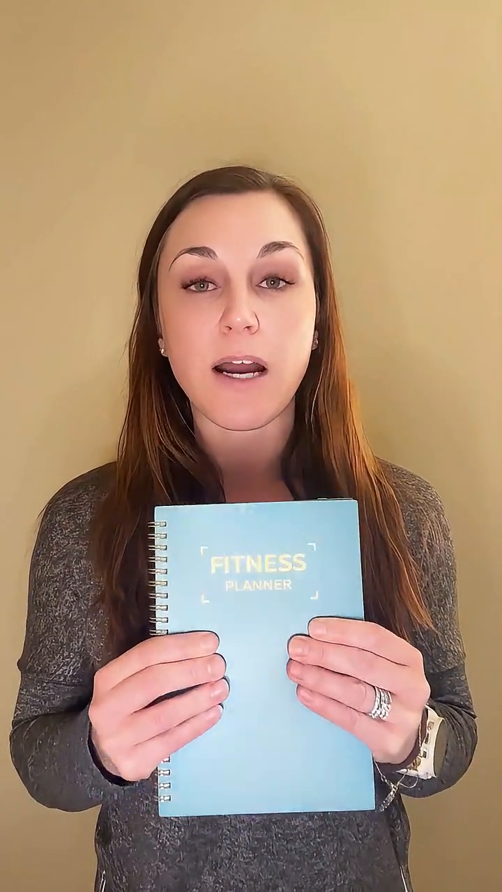 Katelyn showing a fitness planner in a fitness UGC video