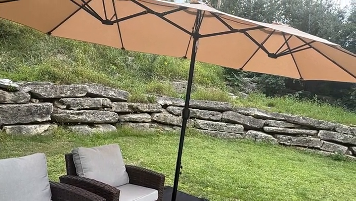 Katelyn reviewing a patio umbrella in a backyard lifestyle UGC video
